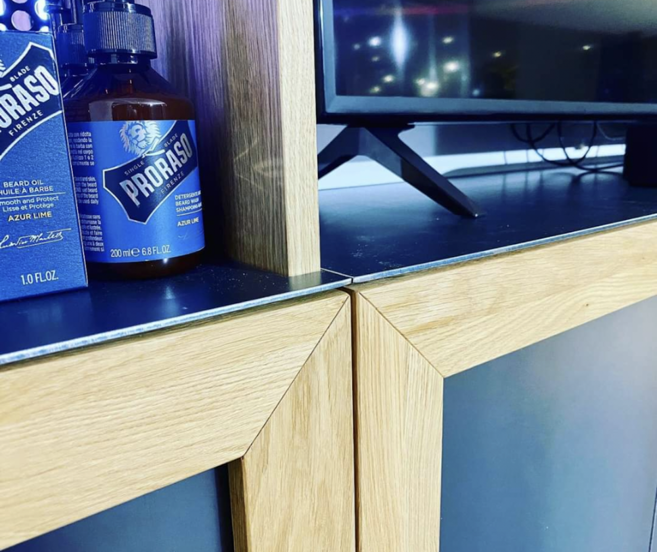 a bottle of beer sitting on top of a tv