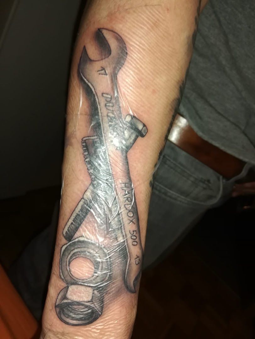 a cover-up tattoo of a saxophone on the wrist, main-tauber-kreis, germany