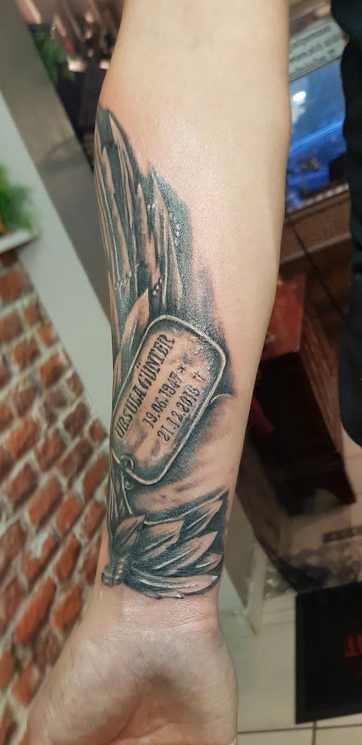 a narben tattoo of a dove with a bible on it, marburg-biedenkopf, germany