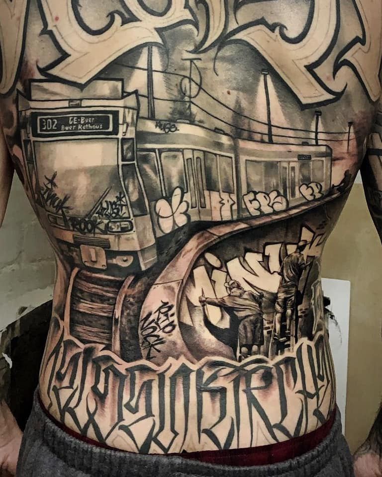 a man with a train cover-up tattoo on his back, hamburg, germany