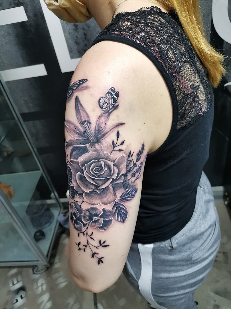 a woman with a black and white rose cover-up tattoo on her arm, kassel, germany