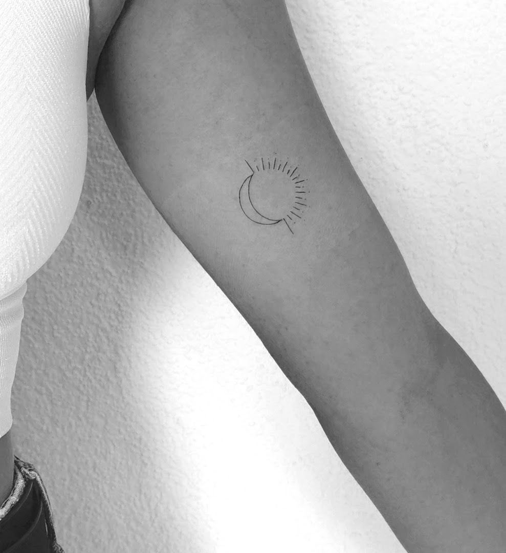 a woman's arm with a small sun narben tattoo on it, breisgau-hochschwarzwald, germany