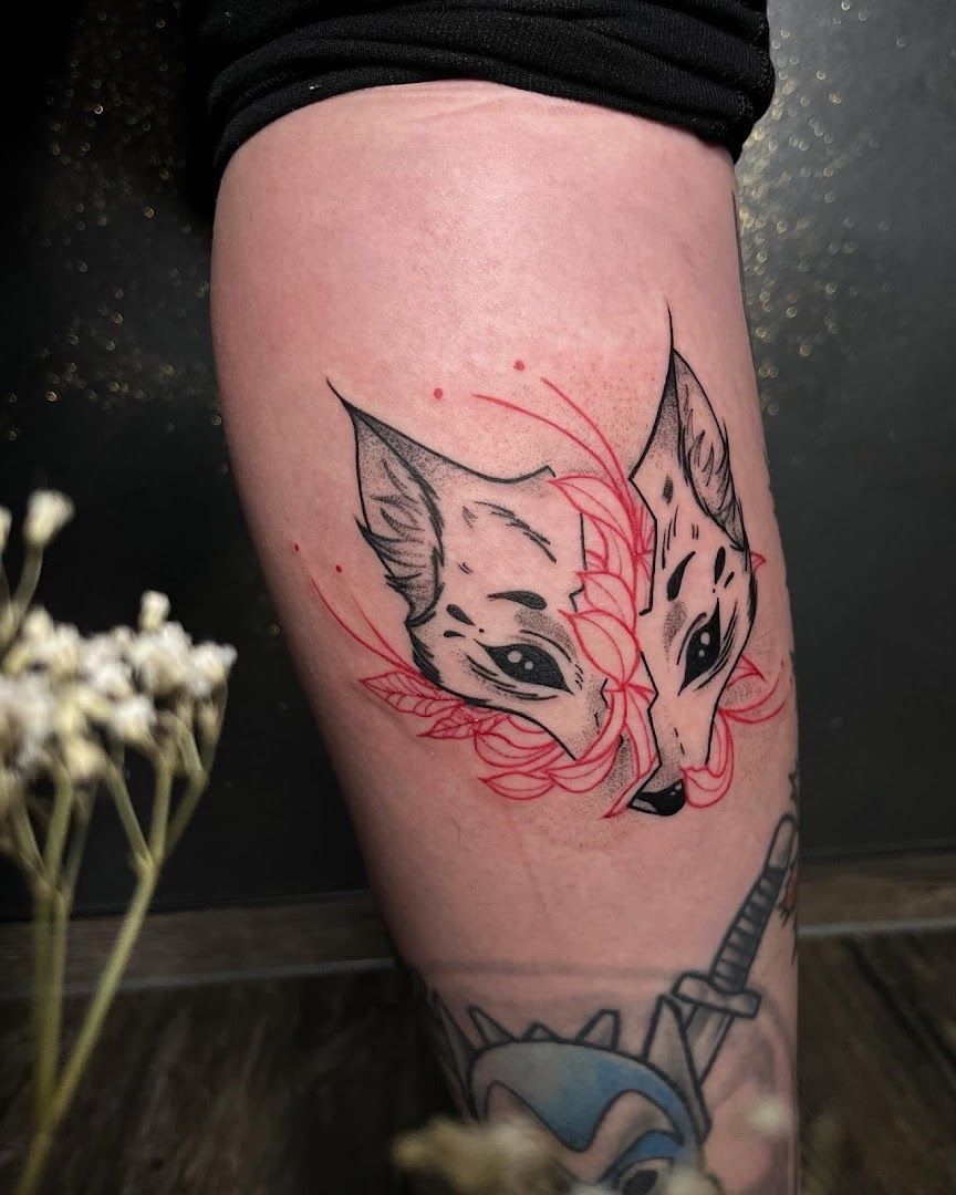 a cover-up tattoo of a cat with red ink on the leg, berlin, germany