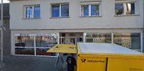 a yellow truck parked in front of a building