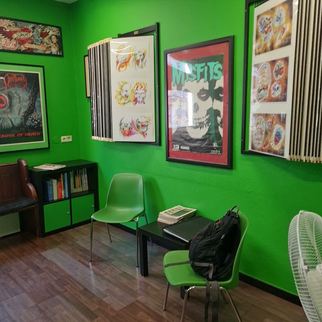 a green room with a desk and chairs