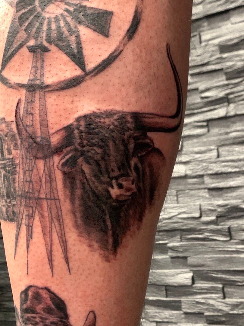 a cover-up tattoo of a buffalo and a windmill, göppingen, germany