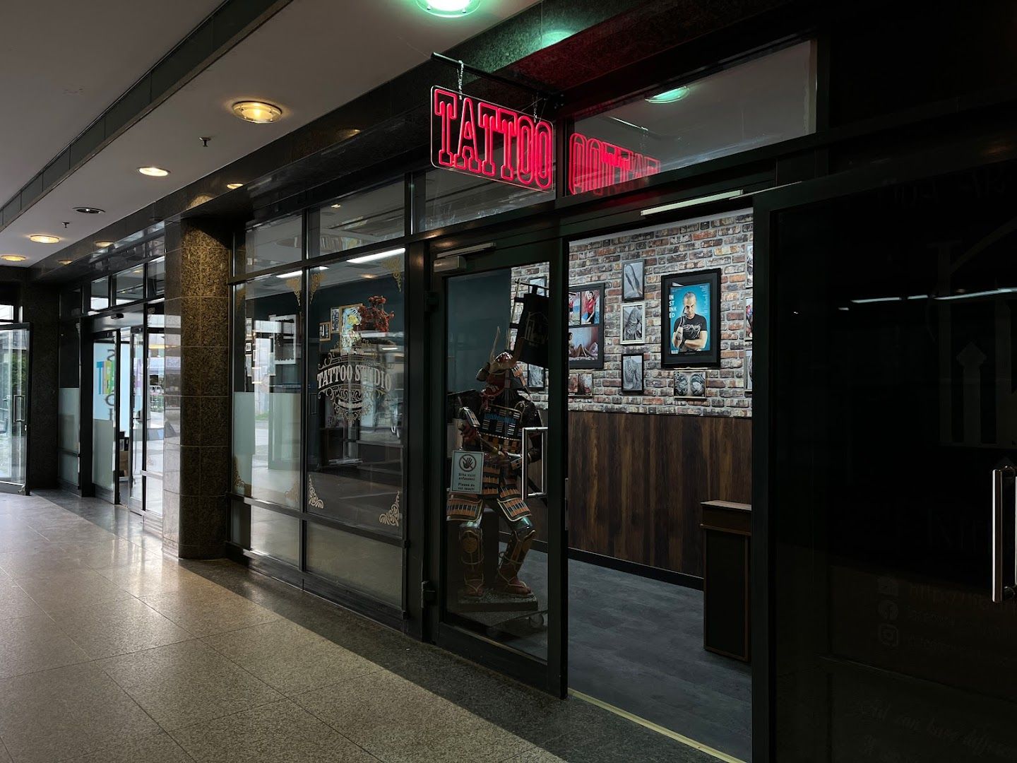 a store front with a neon sign above it