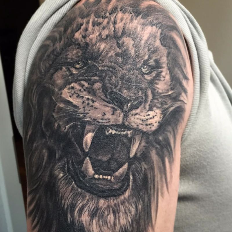 a black and grey blackwork tattoo of a lion, günzburg, germany