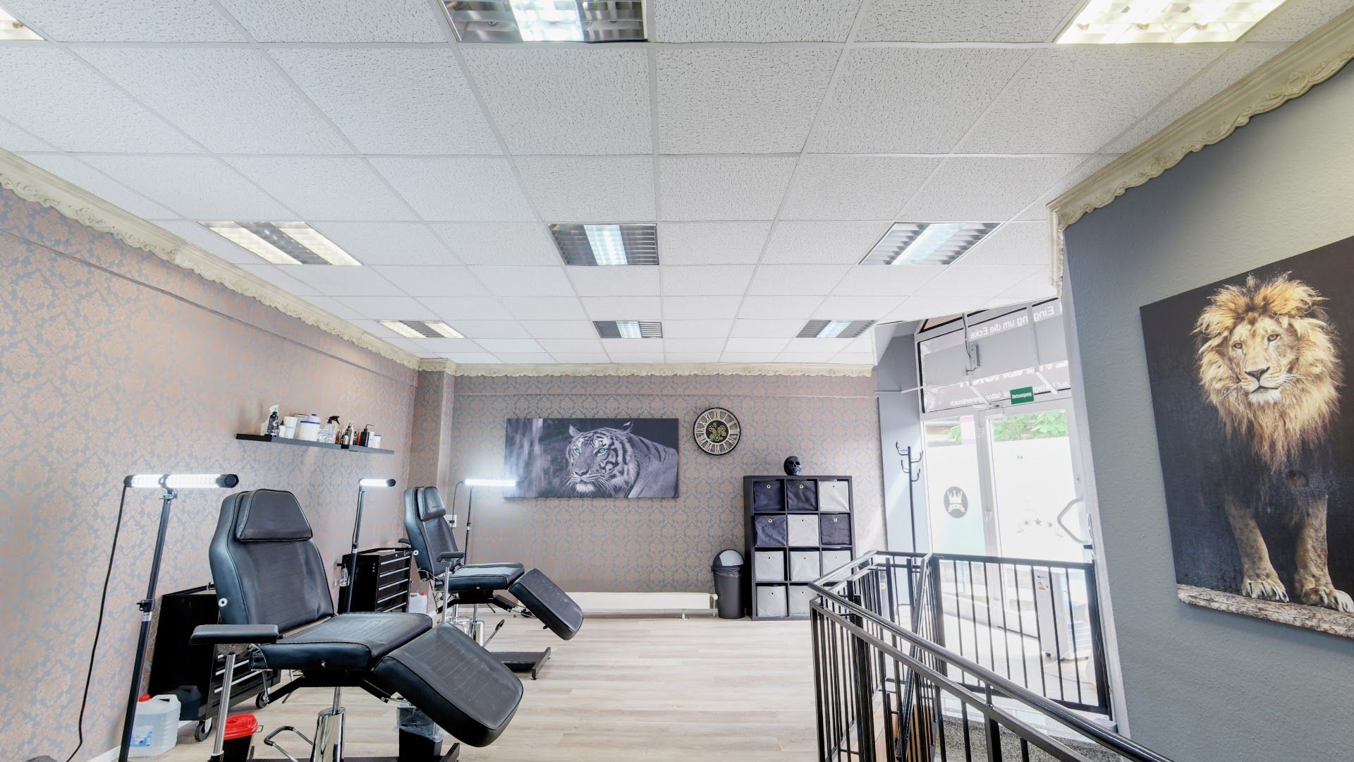 a salon with a large mirror and a wall mural