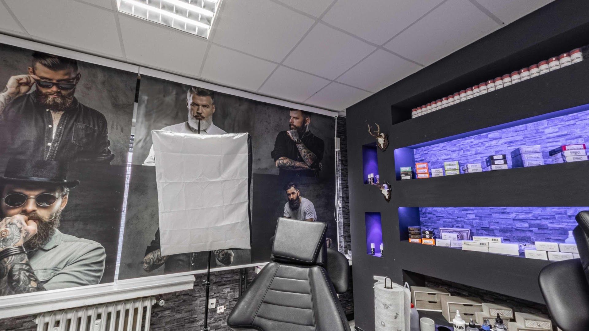 a barber with a large poster on the wall