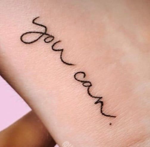 a woman's wrist narben tattoo with the word love on it, märkischer kreis, germany