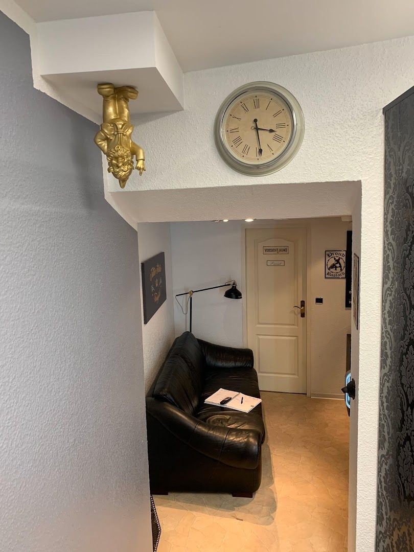 a clock is hanging on the wall in a living room