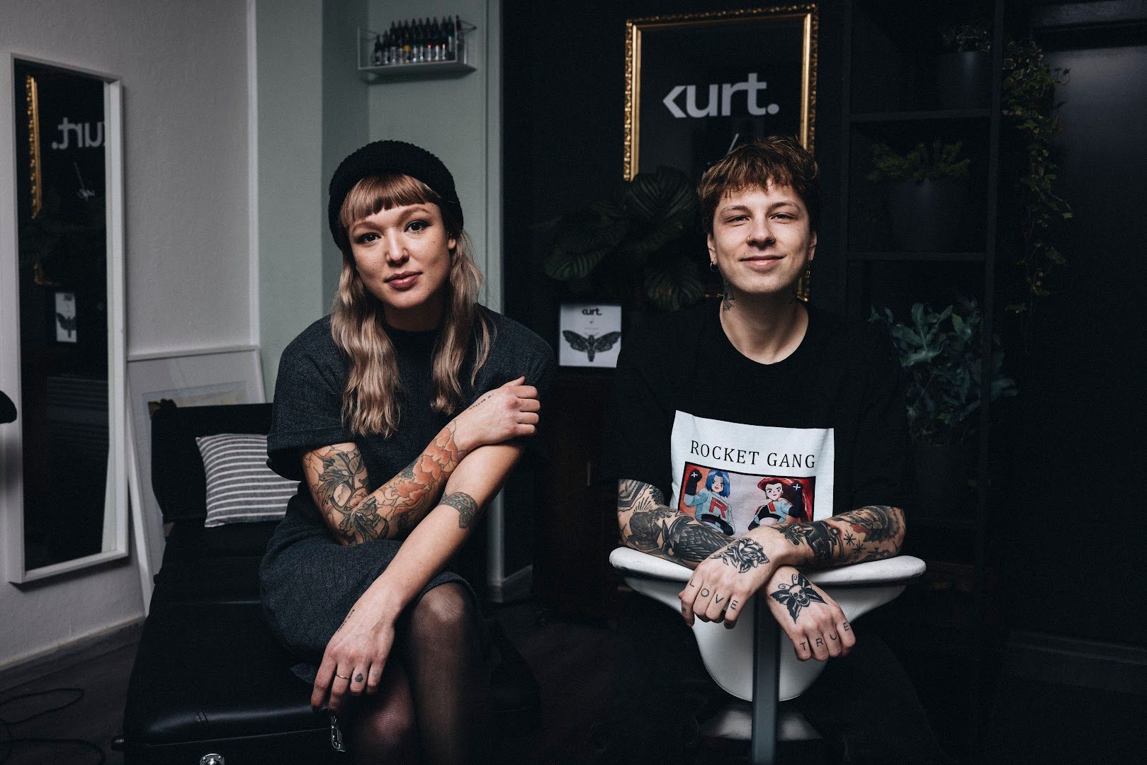 two women sitting on a chair in a room