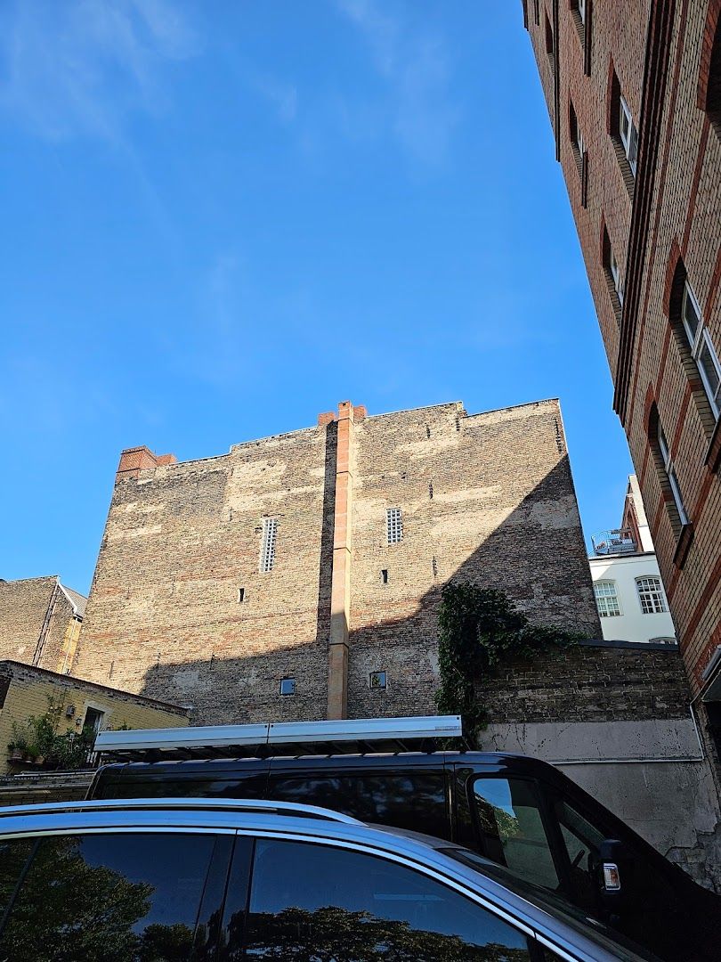 a car parked in front of a tall brick building