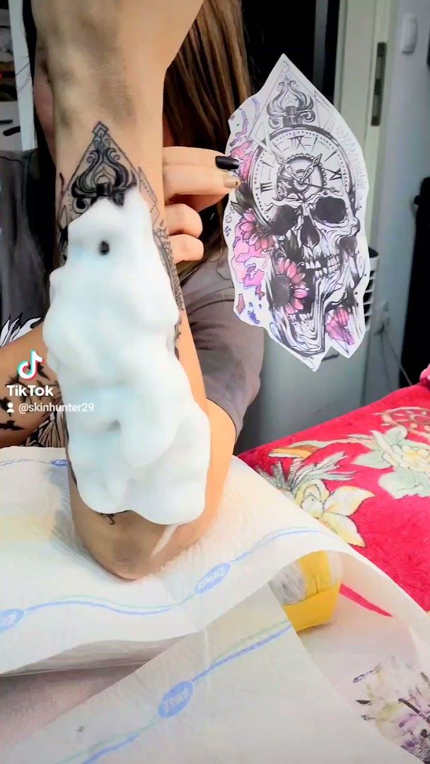 a woman is making a doll with a white rabbit