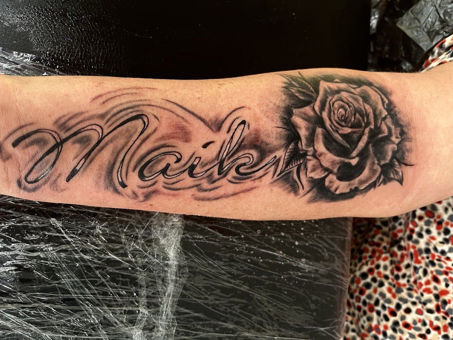 a cover-up tattoo with the word'love'and a rose, bernkastel-wittlich, germany