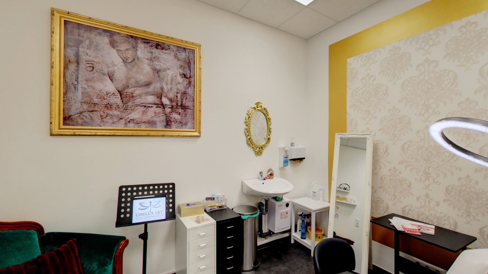 a room with a desk, chair, and mirror