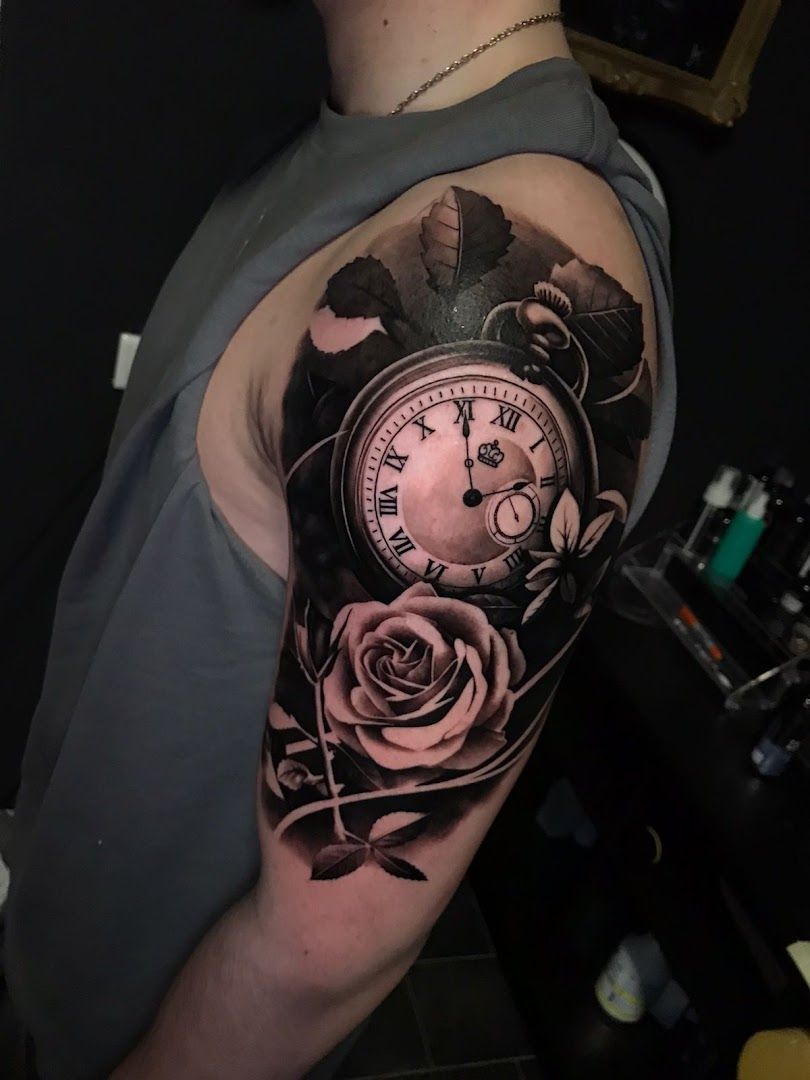 a clock and rose cover-up tattoo on the arm, nürnberg, germany