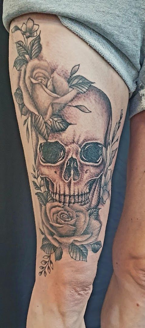 a skull with roses and a rose cover-up tattoo on the leg, ansbach, germany