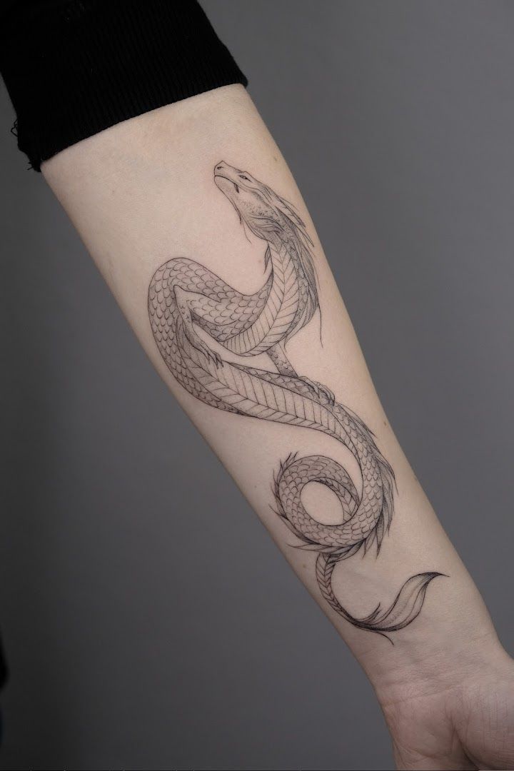 a snake cover-up tattoo on the arm, würzburg, germany