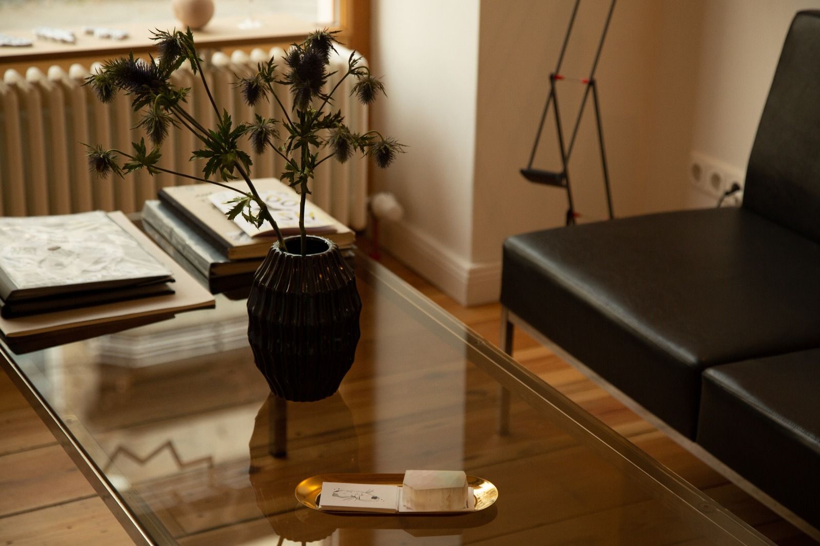 a glass table with a vase of flowers on it