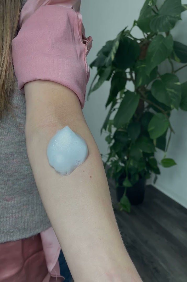 a woman with a blue powder on her arm