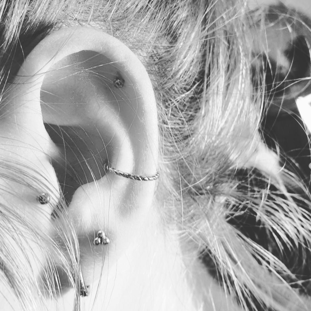 a woman's ear with a piercing