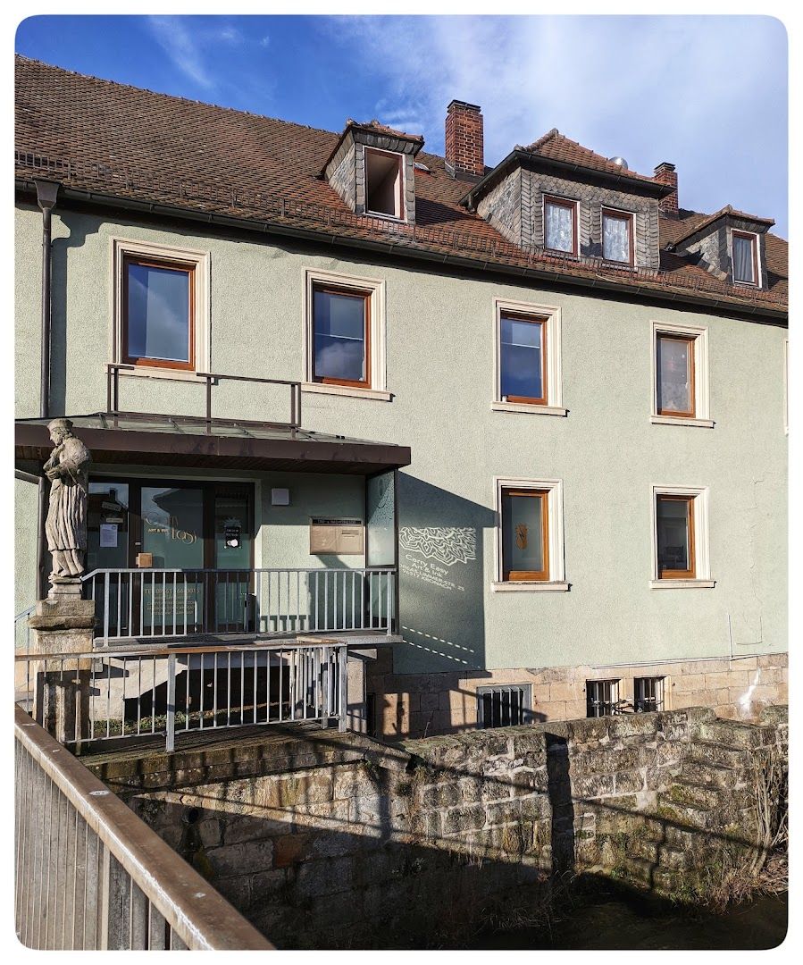 a house with a balcony and a balcony railing