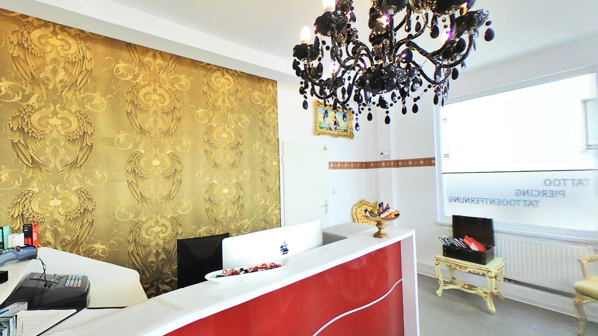 a red and white reception desk with a chandel