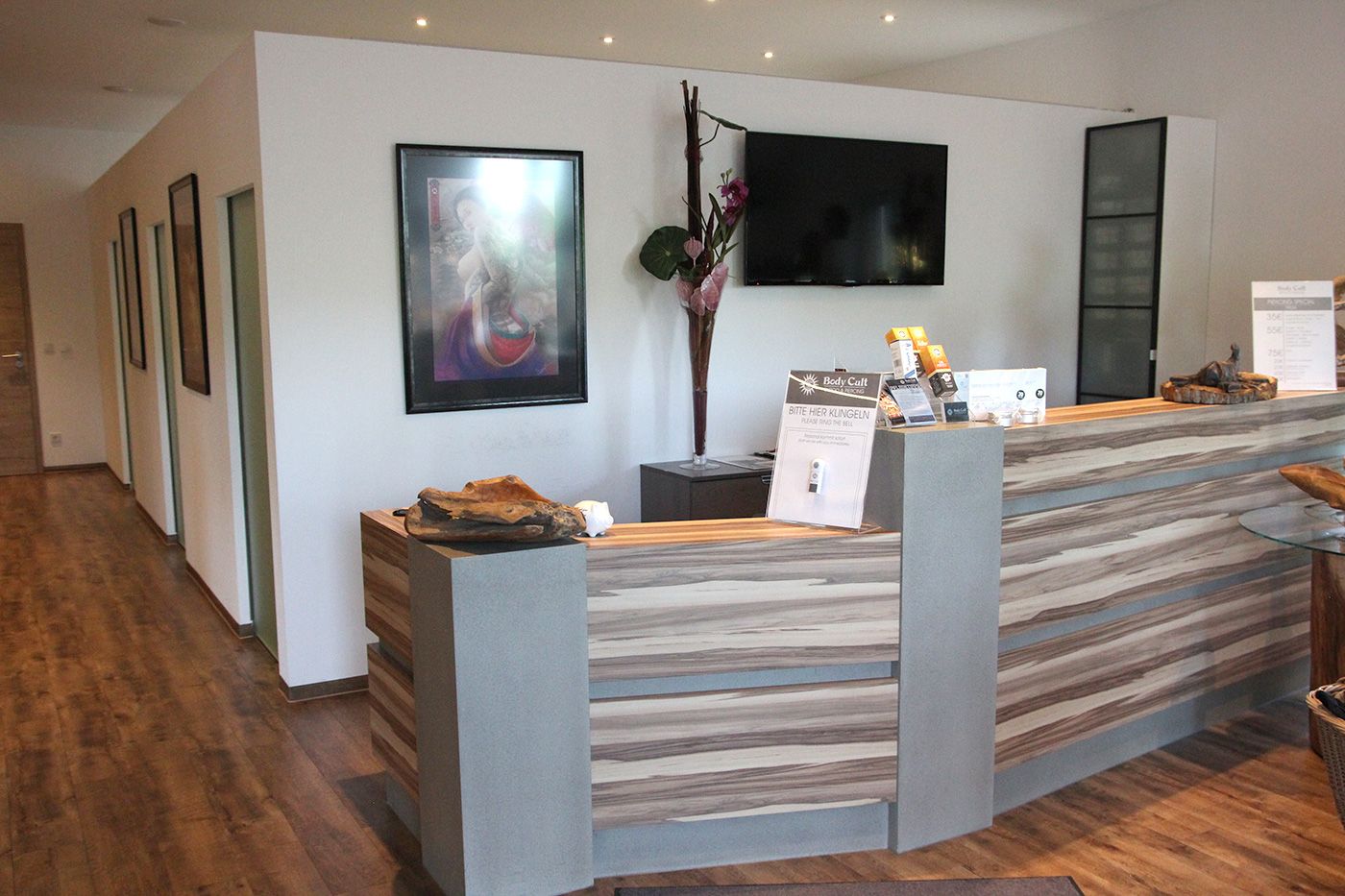 a reception area with a television and a desk