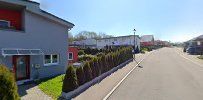 a street with houses and trees in the background