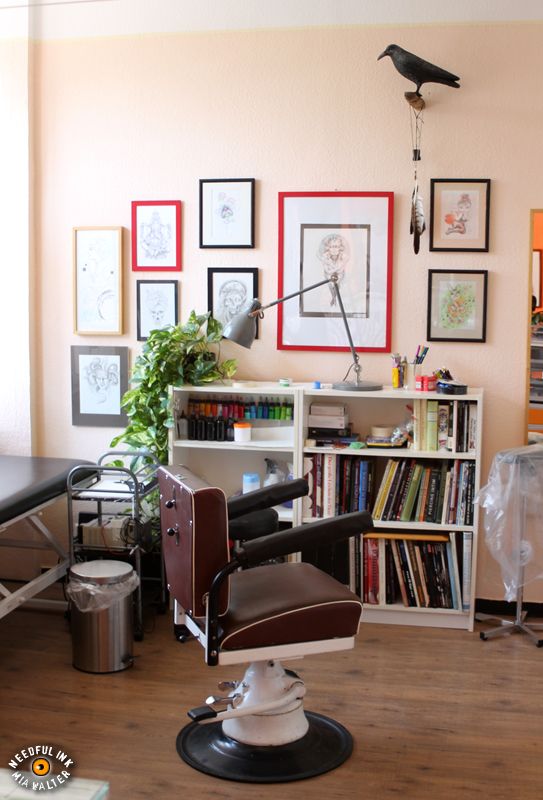 a room with a desk, chair and bookshel