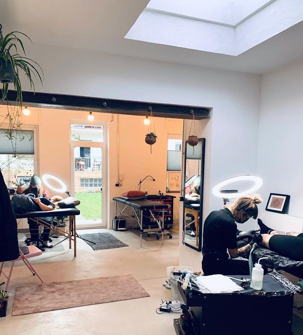 a woman sitting in a salon chair with a hair dryer