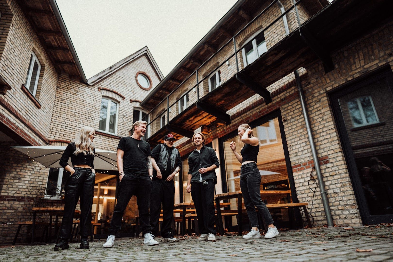 a group of men standing in front of a building