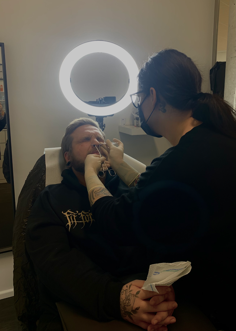 a woman getting her teeth checked by a dentist