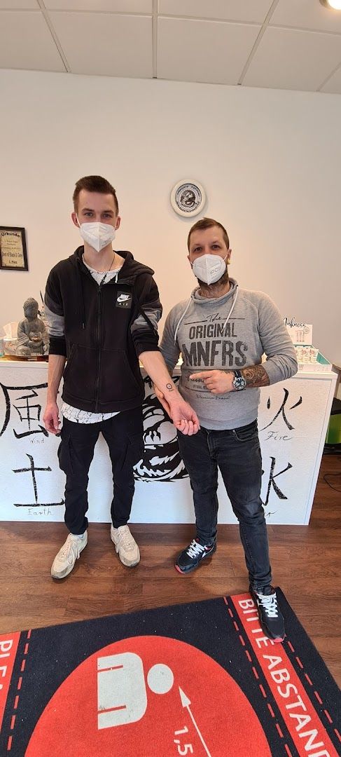 two people in masks sitting on a rug