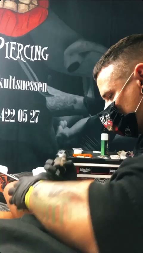 a man with cover-up tattoos is getting his tattoo done, reutlingen, germany