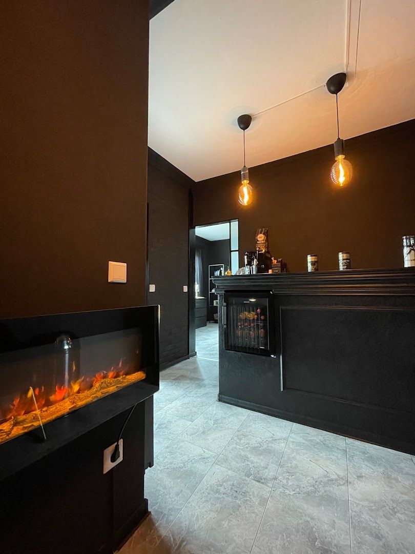 a fireplace in a room with a black wall