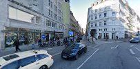 a street with cars and people walking on it