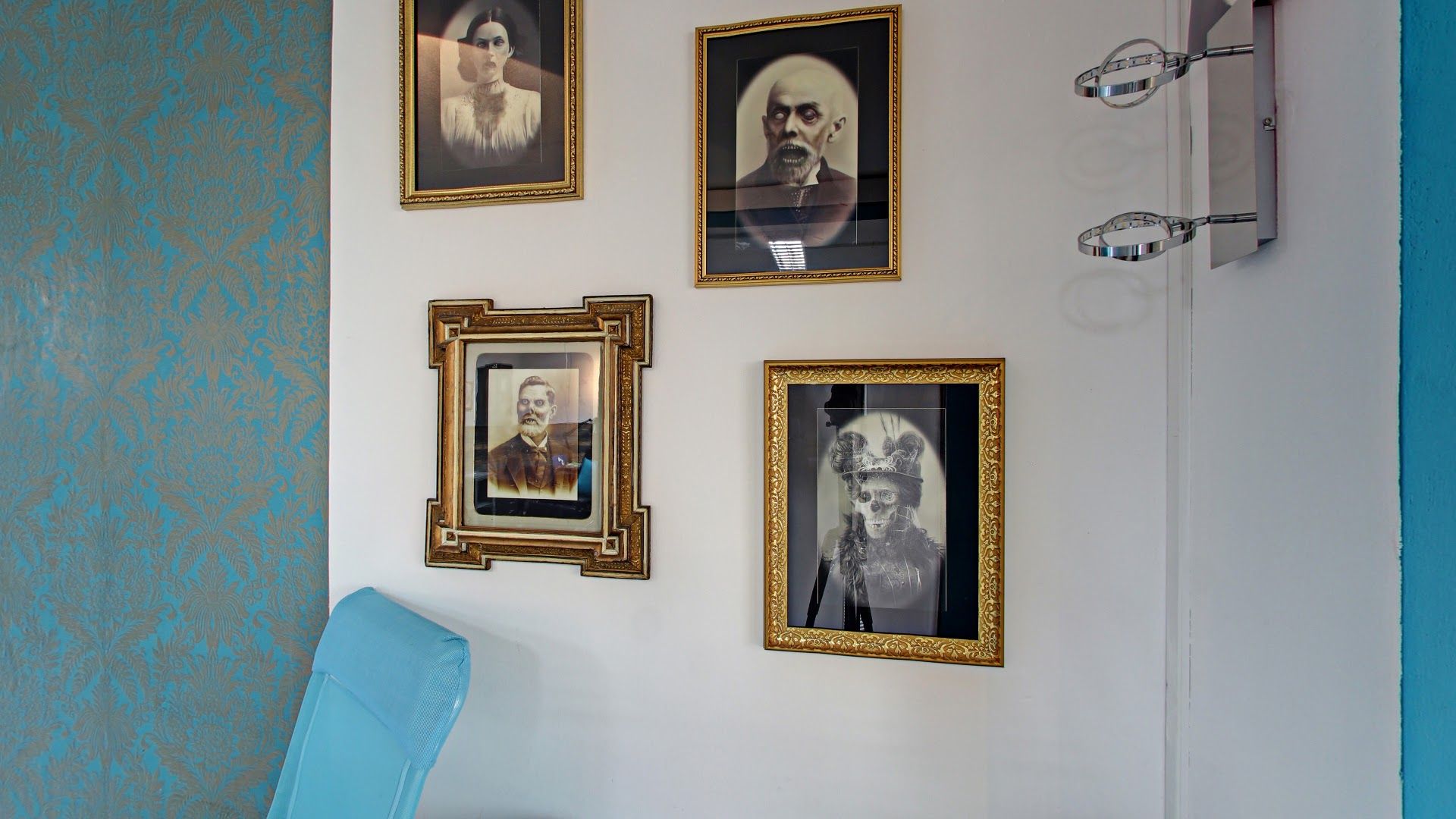 a wall with pictures on it and a chair