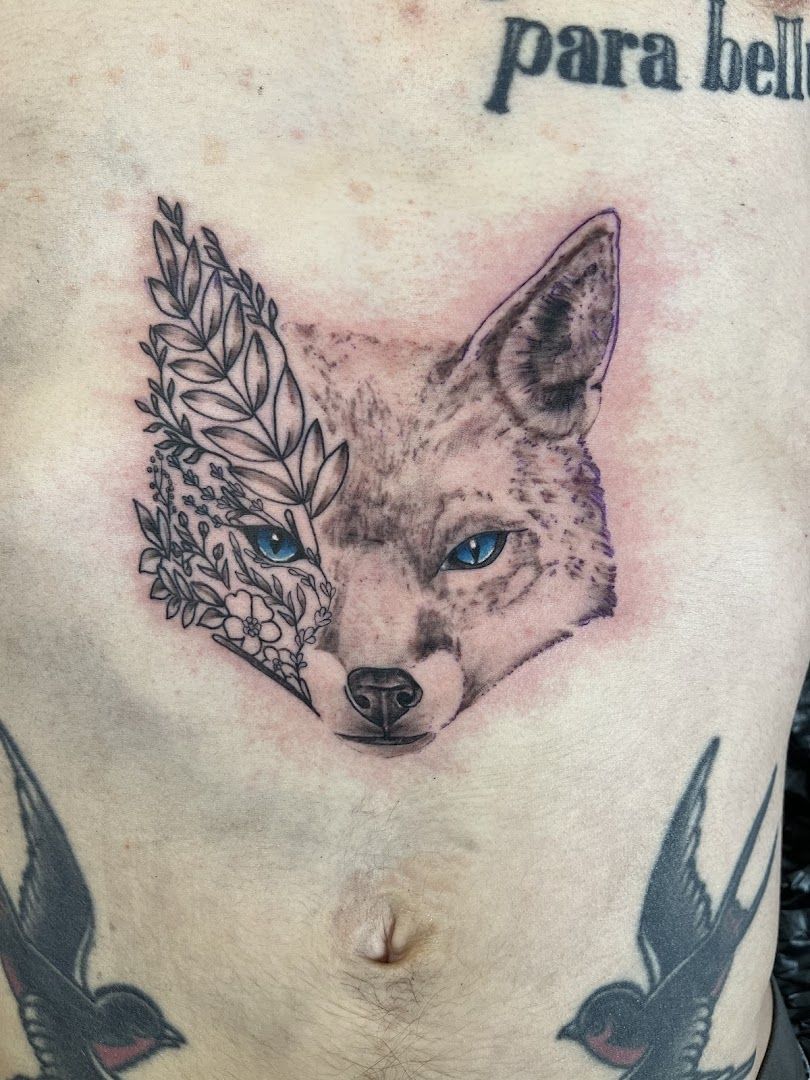 a narben tattoo of a fox with a feather on its head, rems-murr, germany
