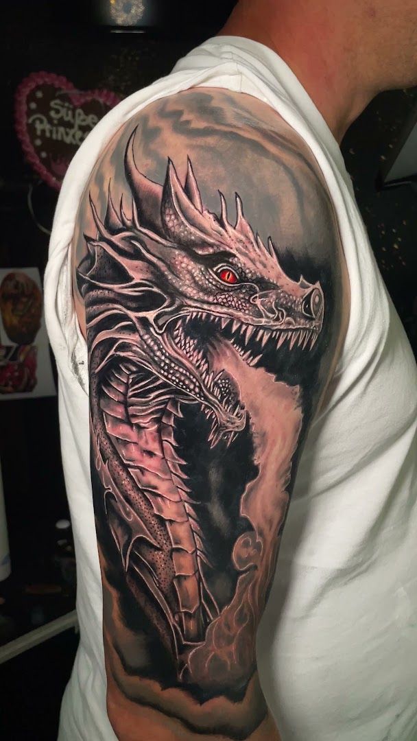 a black and grey dragon narben tattoo on the arm, cuxhaven, germany