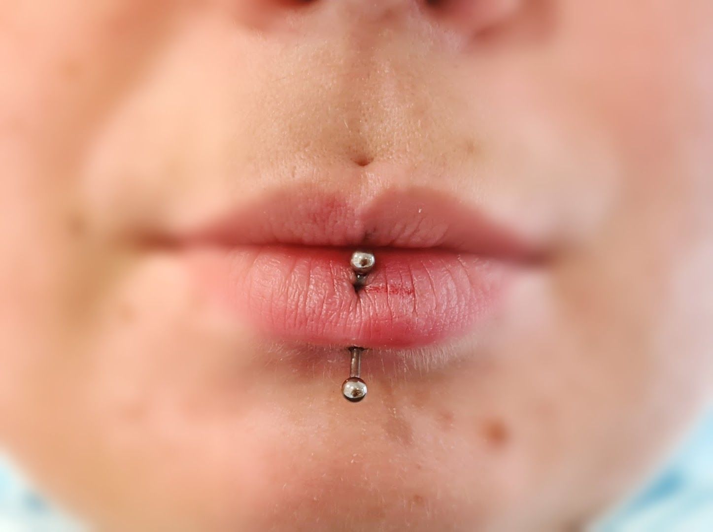 a close up of a person with a piercing on their nose