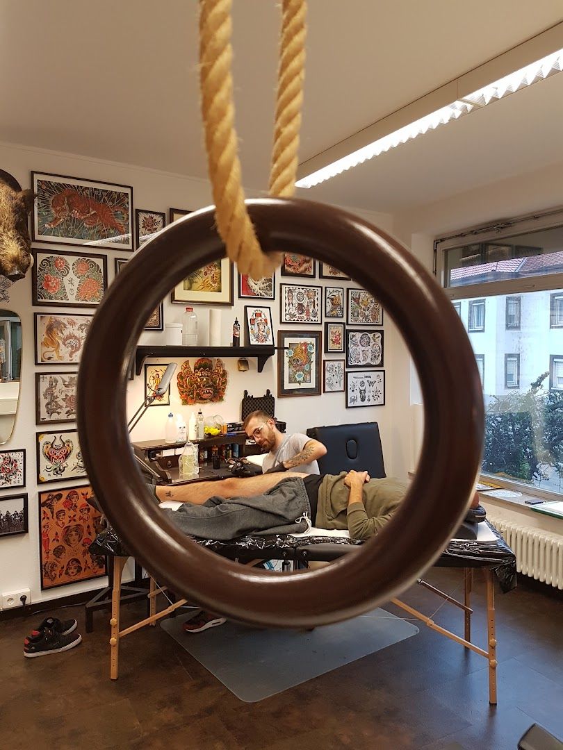 a man is sitting in a chair with a large tire