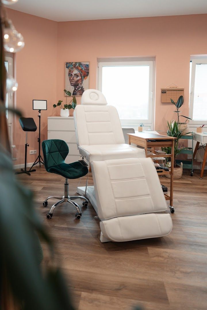 a white recal chair in a room with a pink wall