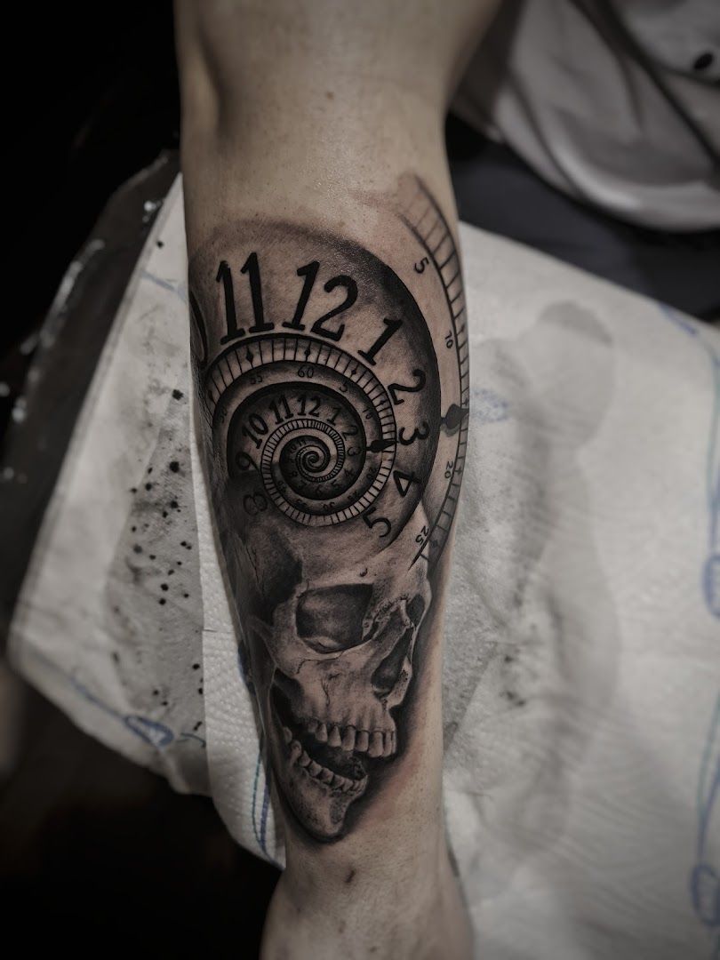 a skull with a clock on it's arm