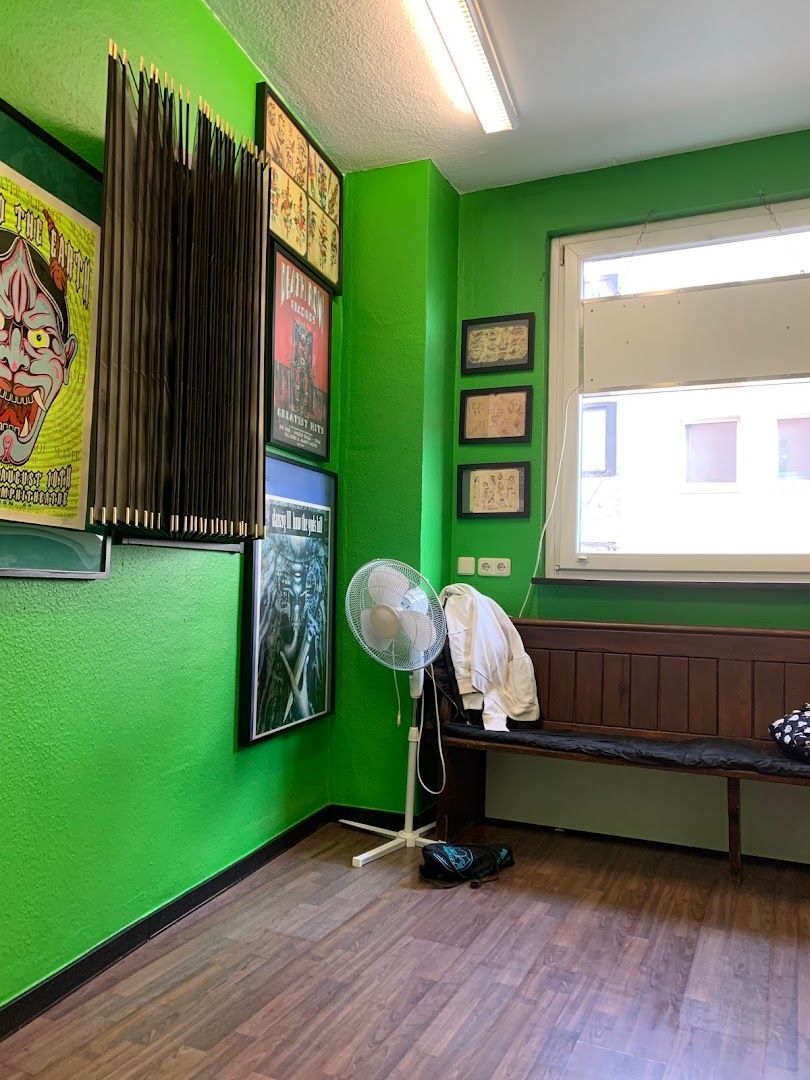 a green room with a bench and a window