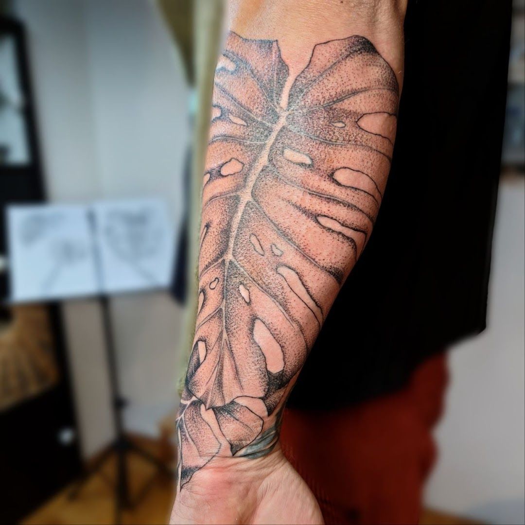 a man's arm with a cover-up tattoo of a leaf, neuburg-schrobenhausen, germany