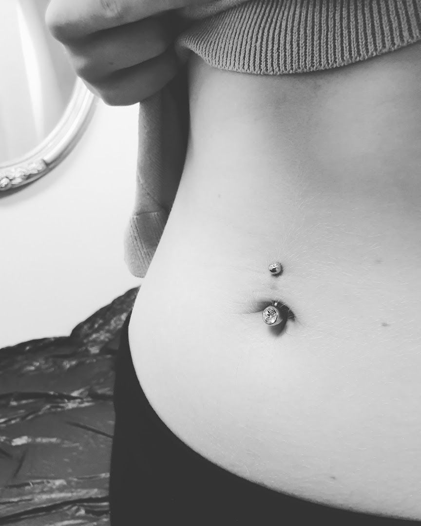 a woman with a small piercing on her stomach