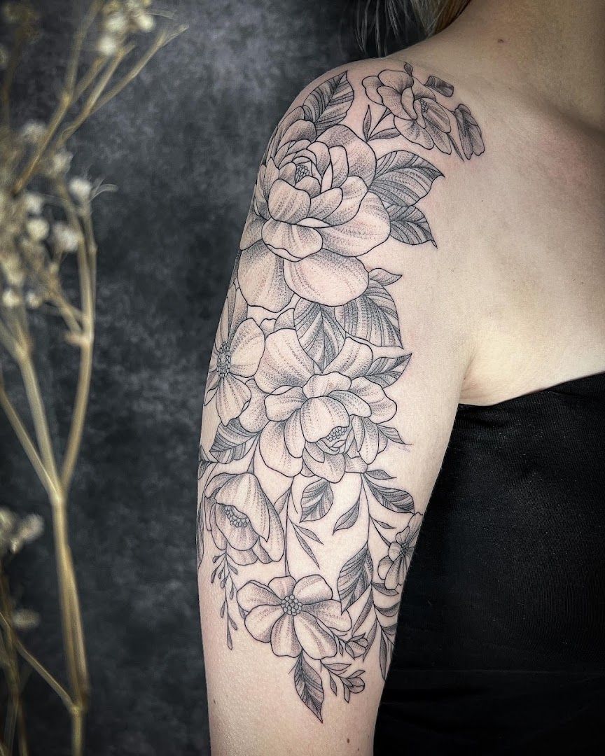 a woman with a black and white flower blackwork tattoo on her arm, kreisfreie stadt freiburg im breisgau, germany